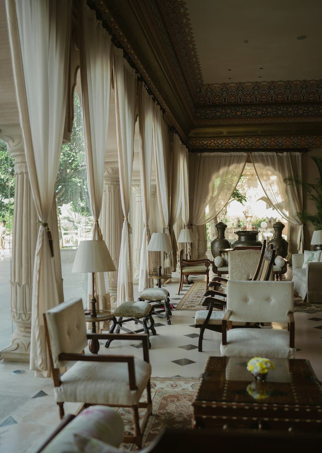Luxurious interior lounge with elegant seating and patterned ceiling.